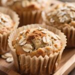 Moist banana oat muffins topped with oats and cinnamon