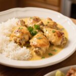 Creamy Smothered Chicken and Rice served on a white plate