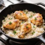 One Pot Chicken and Rice in skillet with seared chicken thighs