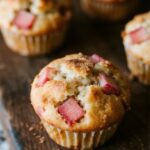 Freshly baked rhubarb muffins on wooden counter